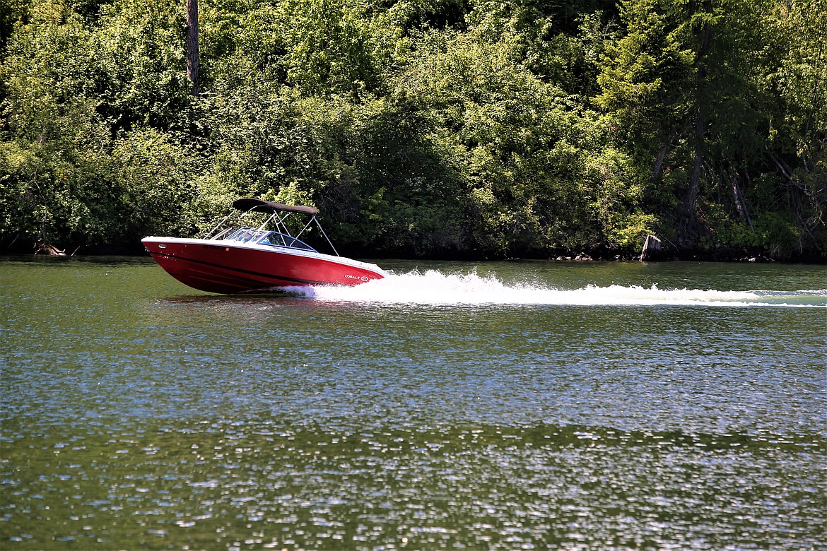 A boat powers up the Spokane River near Atlas Waterfront Park on Thursday.