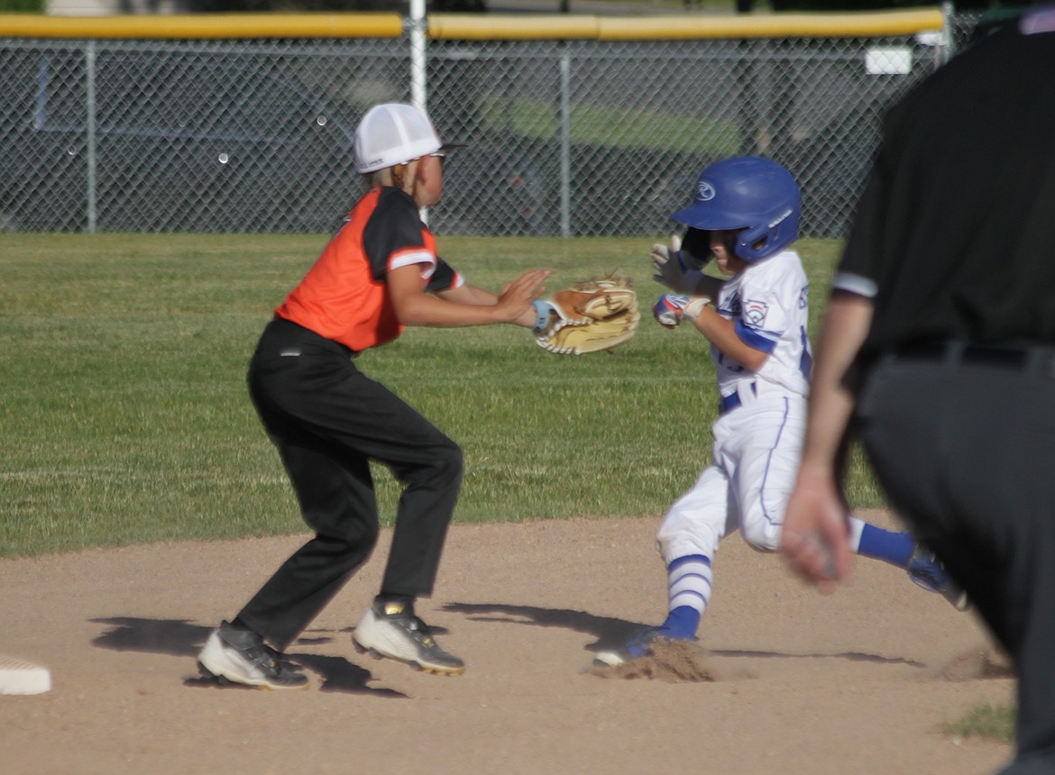 MARK NELKE/Press
Layke Eckhart of Post Falls tags out Cason Bishop of Coeur d'Alene Black during a Little League District 1 10 and under tournament game Friday at Canfield Sports Complex in Coeur d'Alene.