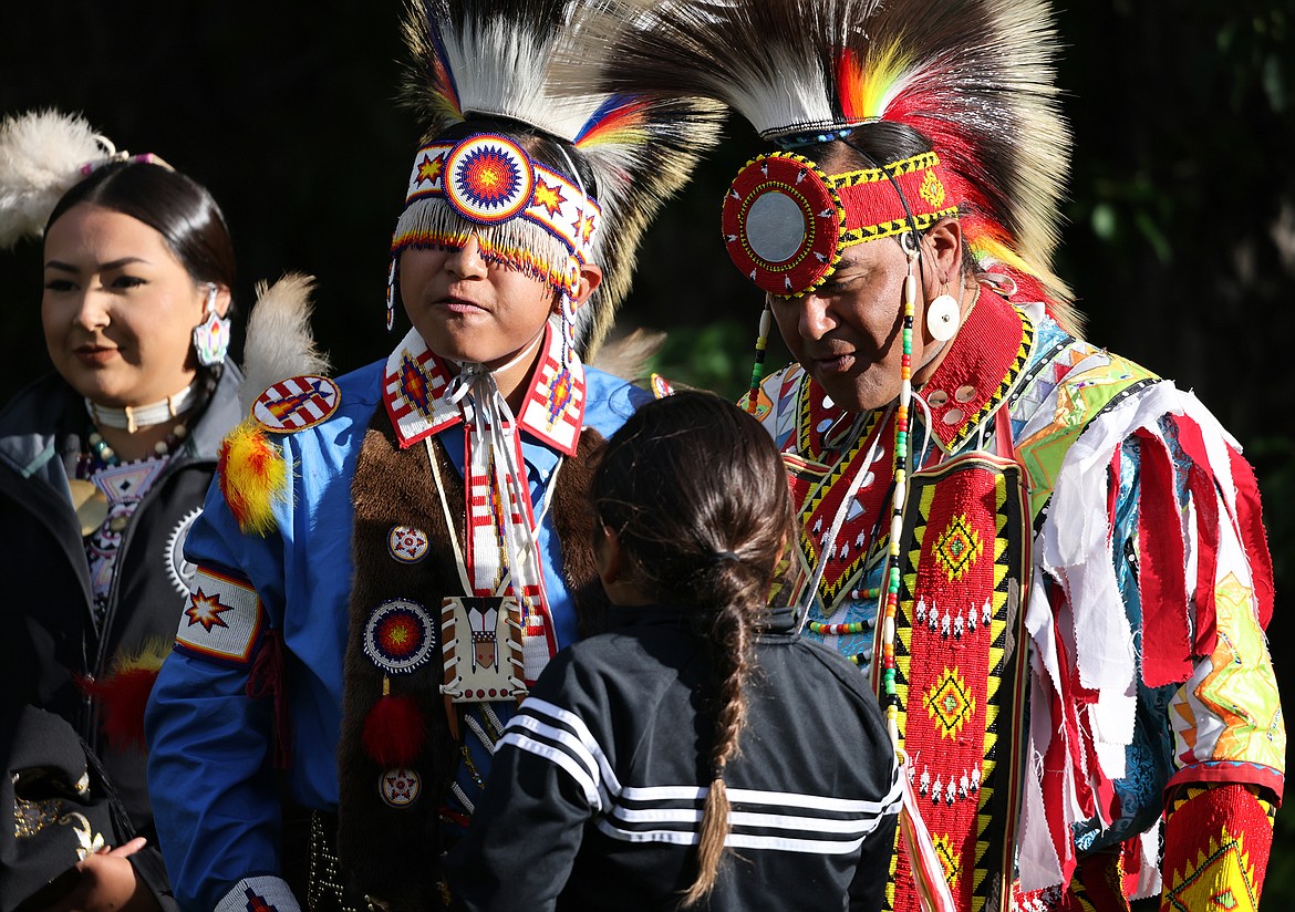 Pat Armstrong Jr (right) and Camdon Croff take time to speak with an onlooker after a performance by the Blackfeet Singers and Dancers at Rising Sun Wednesday, June 29. (Jeremy Weber/Daily Inter Lake)