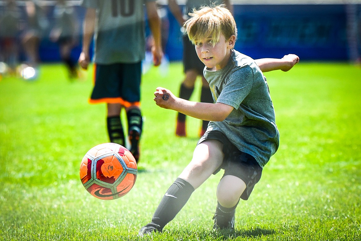 An attendee takes a shot on goal during a drill at Carli Lloyd's CL10 Soccer Clinic at Flip Darling Memorial Field at Columbia Falls High School on Saturday, July 2. Lloyd is a former American professional soccer player; a two-time Olympic gold medalist; two-time FIFA Women's World Cup champion; two-time FIFA Player of the Year and a four-time Olympian. (Casey Kreider/Daily Inter Lake)