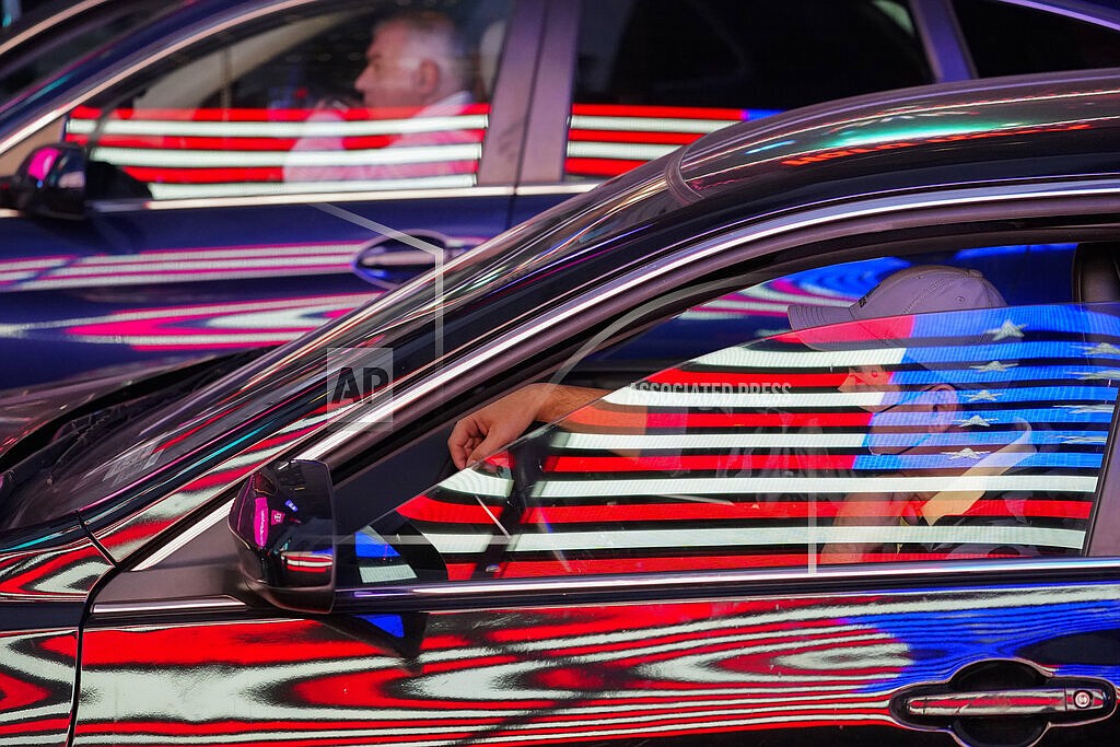 The neon flag on an Army recruiting station is reflected on cars at a red light in New York's Times Square, Oct. 14, 2021. The hand of federal regulation reaches into those cars, governing safety equipment, mileage standards and more, just as it touches everything we consume, the air we breathe, the water we use. (AP Photo/Mary Altaffer, File)