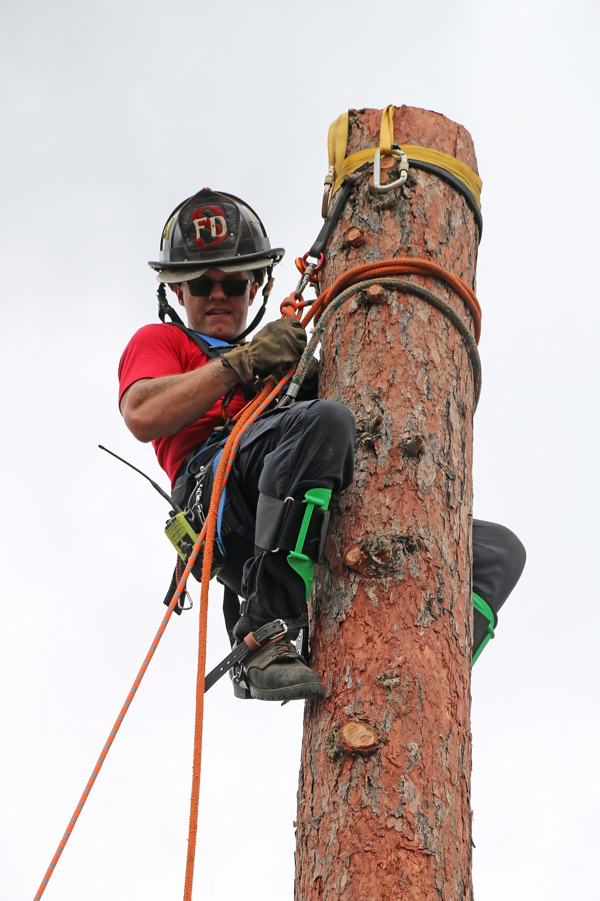 An area firefighter practices climbing a spar pole during a mid-June training exercise on tree rescues.