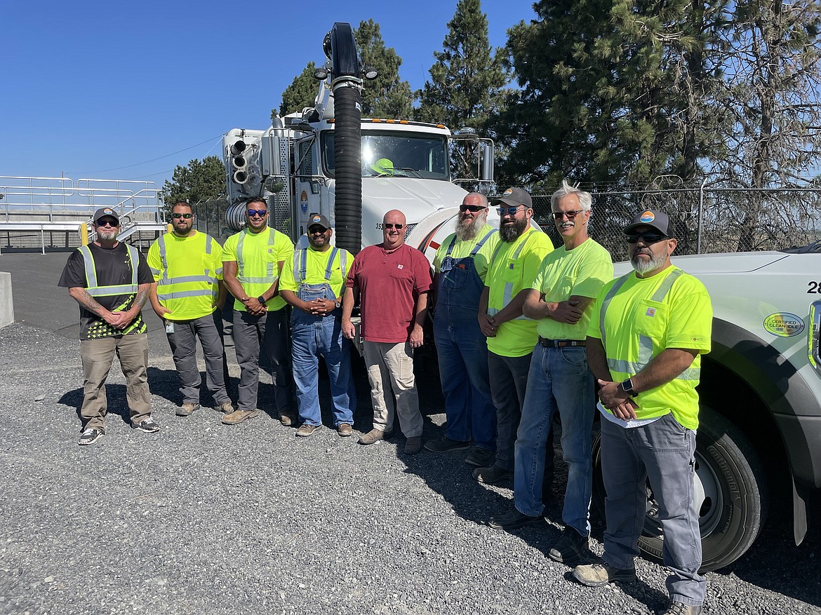 Moses Lake city Wastewater Manager Chris Campbell (left) with the city’s wastewater treatment crew — (left to right) Justin Akerley, Zach Martinez, Gary Vela, Joey Barkle, Dustin Roth, Alex Morton, Franklin Ridgeway, Ignacio Deleon — at the Dunes Wastewater Treatment Plant last week. Pictured behind them is one of the city’s giant rodder trucks used to clean and maintain city sewers.