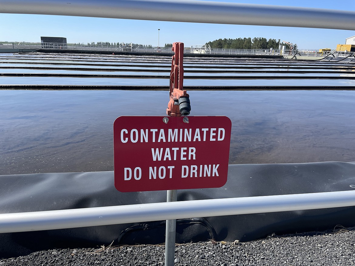 A sign on a spigot next to one of the wastewater treatment ponds at the Dunes Wastewater Treatment Plant, one of two operated by the city of Moses Lake. While the water is brown and murky, the majority of the coloration doesn't come from feces - rather, it is produced by bacteria that break down waste.