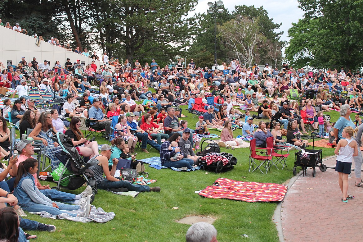 Crowd members stake out their spaces on the grass for the free LoCash concert at Centennial Amphitheater in Moses Lake Saturday.