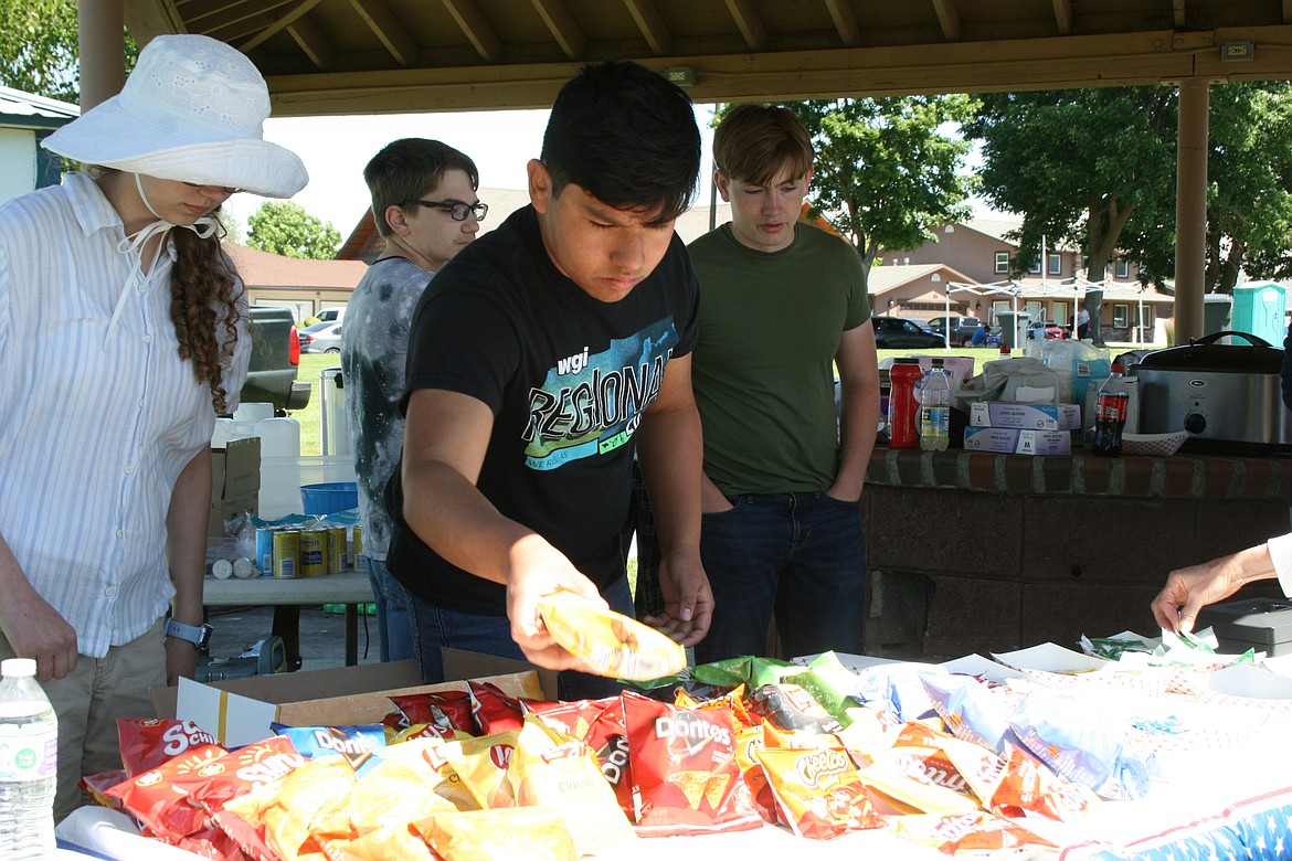 Students in the Othello High School music program worked the hamburger booth in the afternoon, after working the pancake breakfast in the morning, with the Othello Rotary.