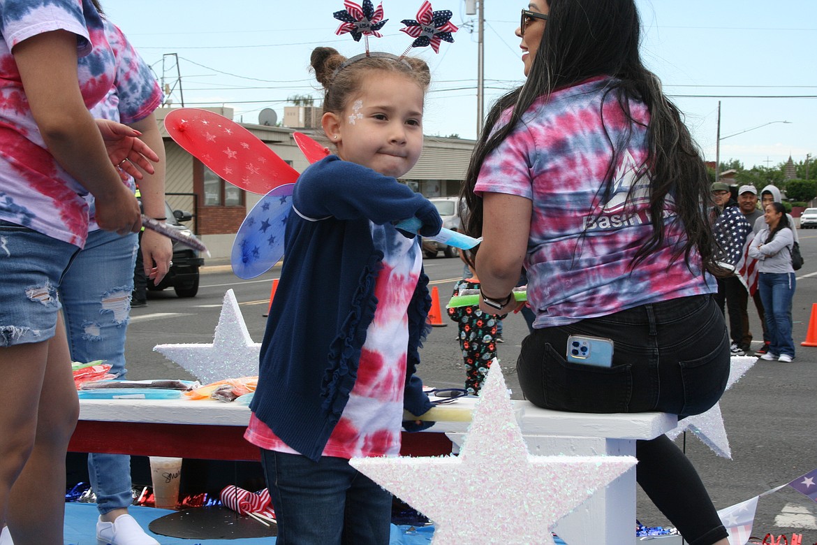 A participant prepares to throw an ice pop during the July 4 parade in Othello.