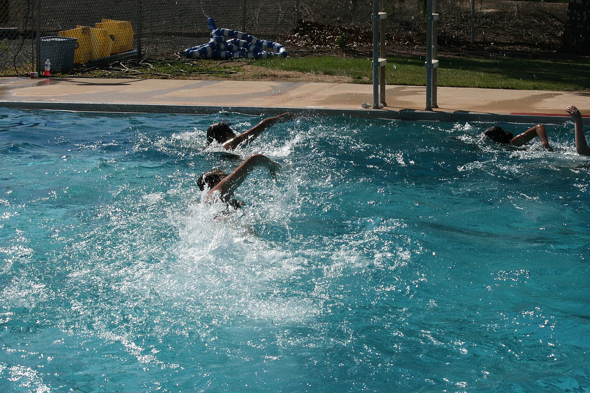 Quincy swim team members engage in an impromptu race at the end of Friday’s practice.