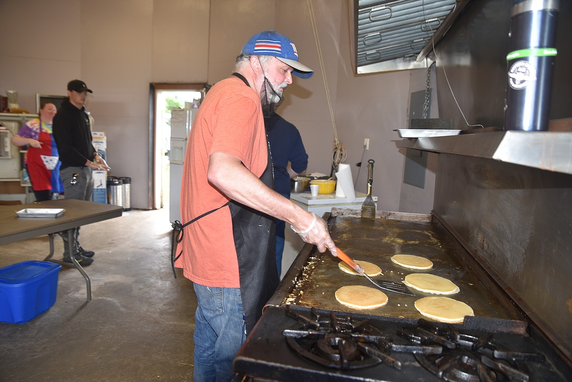 Rob Bowles flips flapjacks for the Troy Chamber of Commerce's breakfast on Monday at Roosevelt Park during Troy's Old Fashioned Fourth of July parade. (Scott Shindledecker/The Western News)