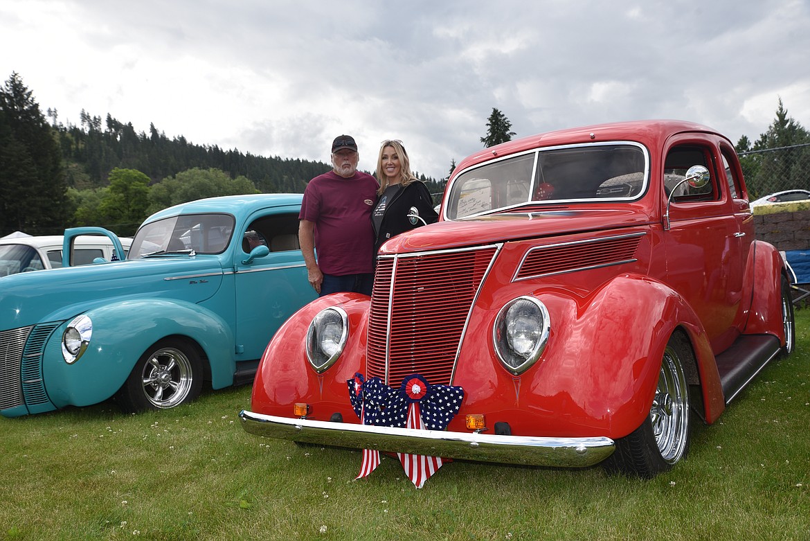 Ron Hooten and his daughter, Jodi Hooten, of Trout Creek show off their 1937 Ford Slantback on Monday at the car show at Roosevelt Park during Troy's Old Fashioned Fourth of July parade. (Scott Shindledecker/The Western News)