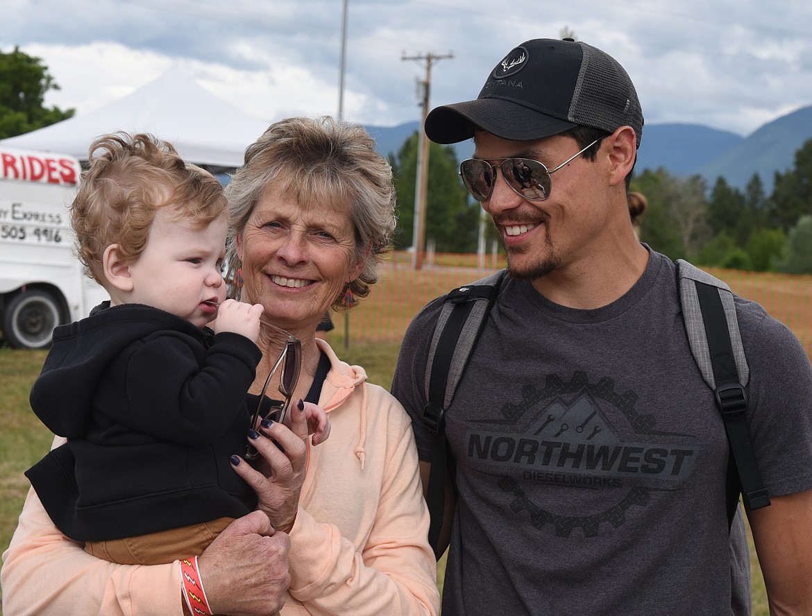 Jill Ursua of Arlee enjoys the Freedom Fest activities with her son and grandson. (Marla Hall/For the Leader)