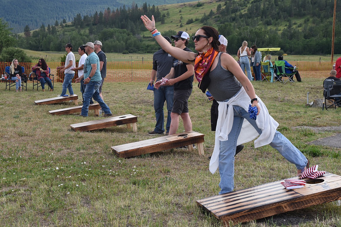 Competitors warm up for the cornhole competition at Freedom Fest. (Marla Hall/For the Leader)