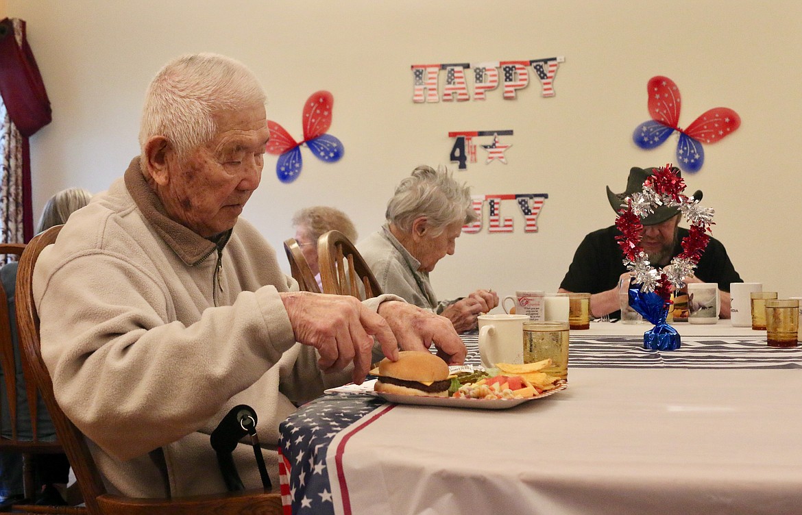 Residents of the Restorium enjoying the Fourth of July luncheon.