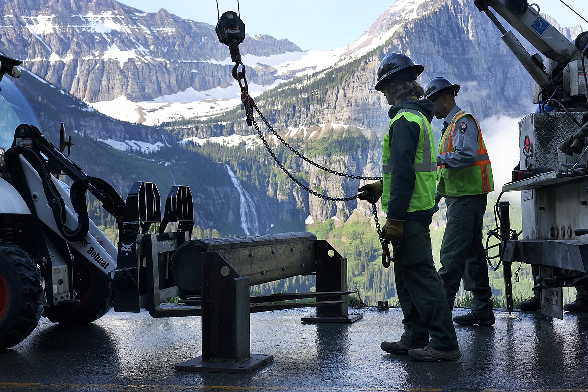 Workers install one of the more than 500 wooden guardrails on the Going to the Sun Road in Glacier National Park Tuesday, July 5. (Jeremy Weber/Daily Inter Lake)
