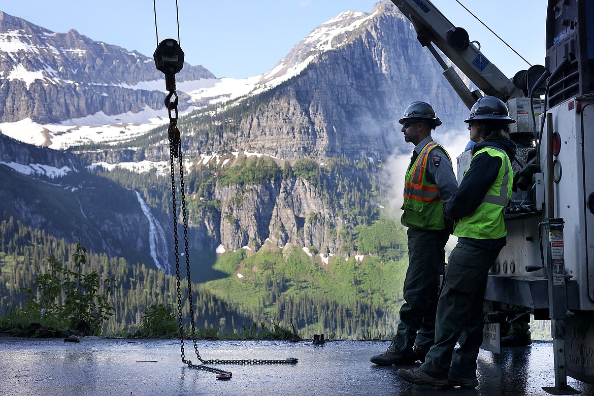 Workers take a break between installing the more than 500 wooden guardrails on the Going to the Sun Road in Glacier National Park Tuesday, July 5. (Jeremy Weber/Daily Inter Lake)