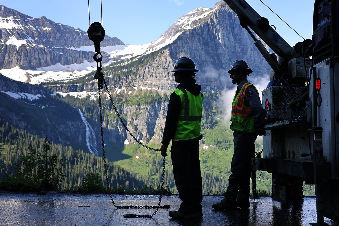 Workers take a break between installing the more than 500 wooden guardrails on the Going to the Sun Road in Glacier National Park Tuesday, July 5. (Jeremy Weber/Daily Inter Lake)