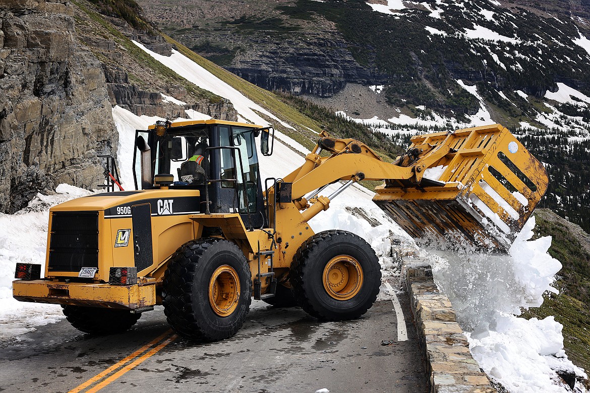 Crews work to clear the remaining snow from Logan Pass on Going to the Sun Road in Glacier National Park Tuesday, July 5. The park says the road will not open until July 13 at the earliest. (Jeremy Weber/Daily Inter Lake)