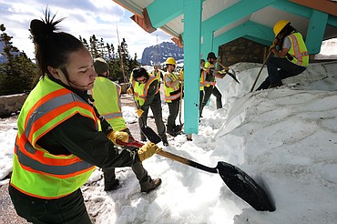 Crews clear the snow from the Logan Pass Visitor Center at the top of Going to the Sun Road Tuesday, July 5. Park officials say the road will not be open until July 13 at the earliest. (Jeremy Weber/Daily Inter Lake)
