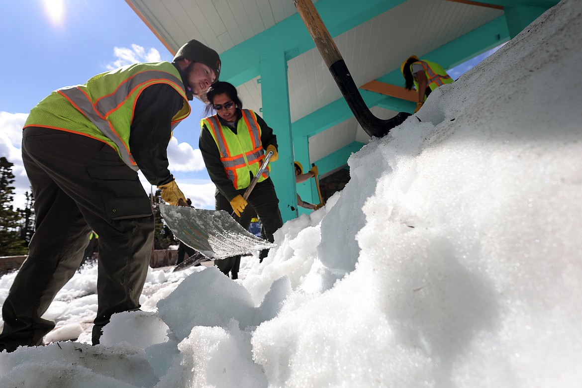 Crews clear the snow from the Logan Pass Visitor Center at the top of Going to the Sun Road Tuesday, July 5. (Jeremy Weber/Daily Inter Lake)