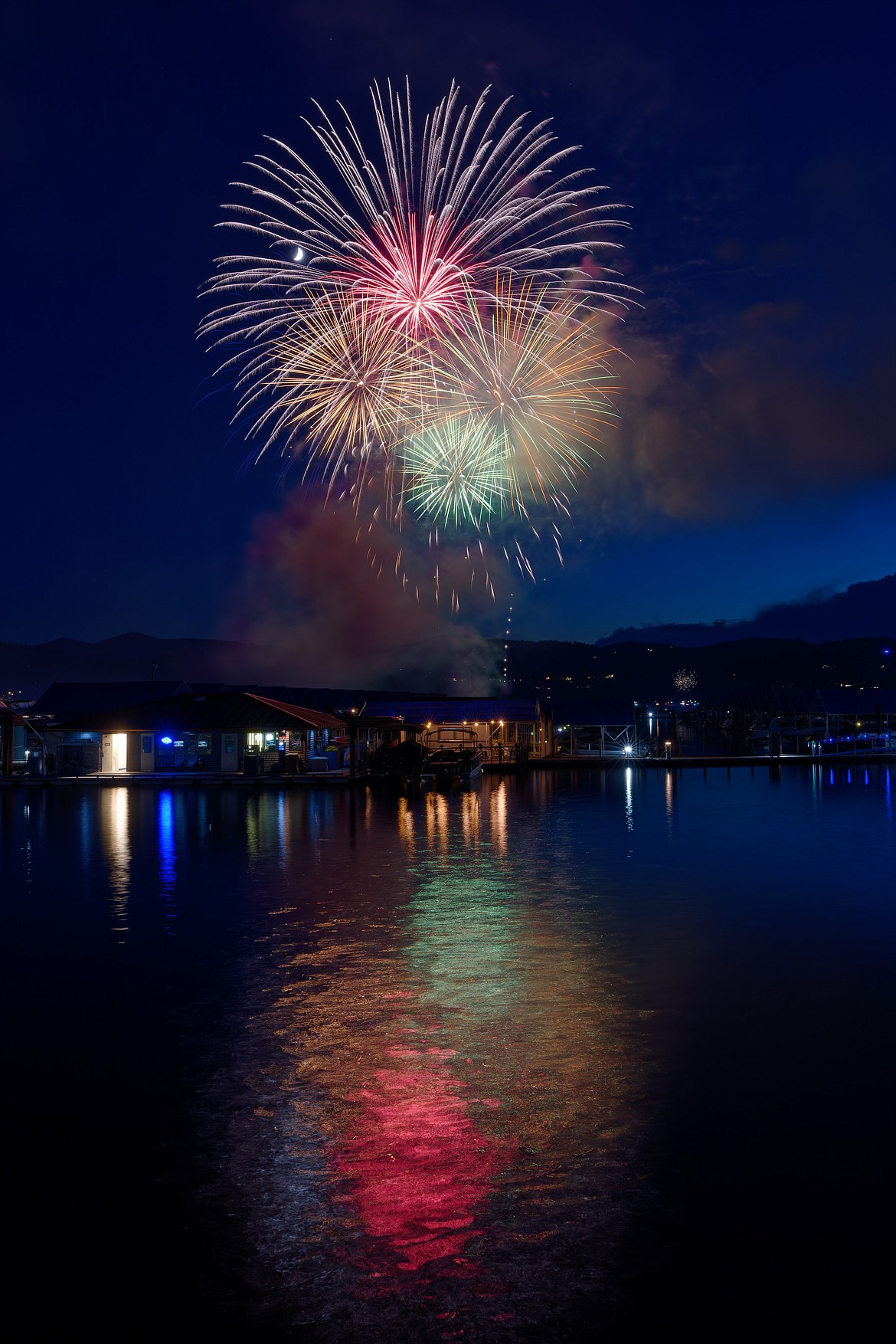 Colors explode across the sky over Lake Coeur d'Alene during the 2022 annual Fourth of July fireworks show.