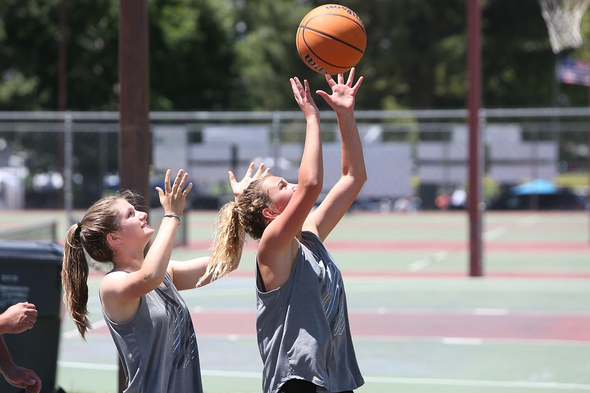 Two players fight for a rebound on the basketball courts in Lions Park in Othello on Monday. The three-on-three tournament was held as part of the Fourth of July celebration.