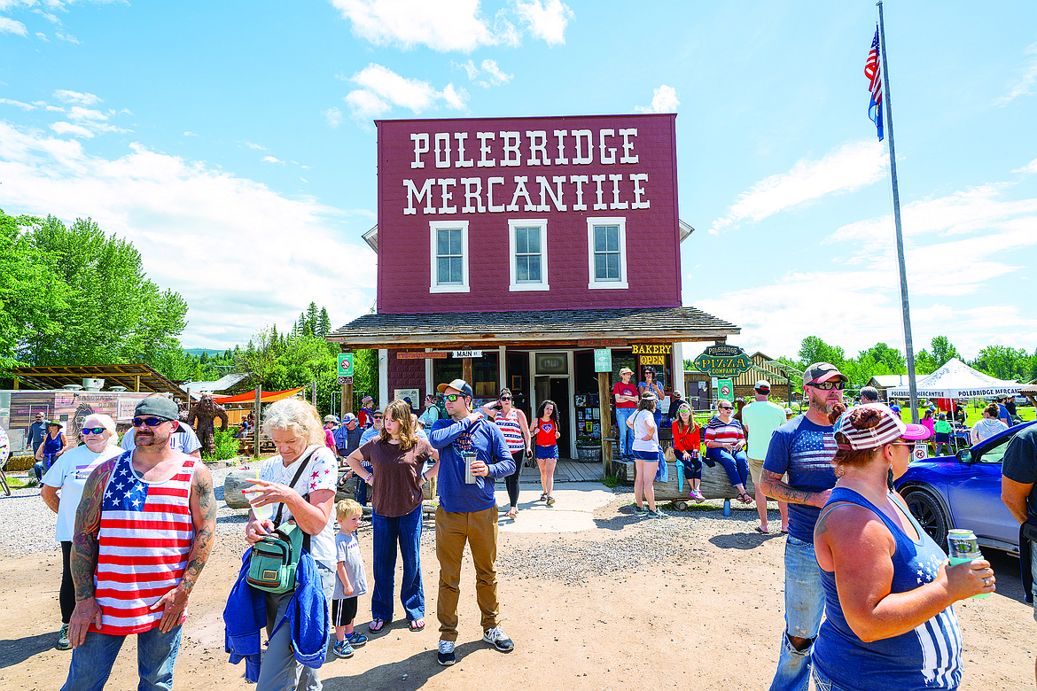 The crowd watches the parade return to Polebridge.