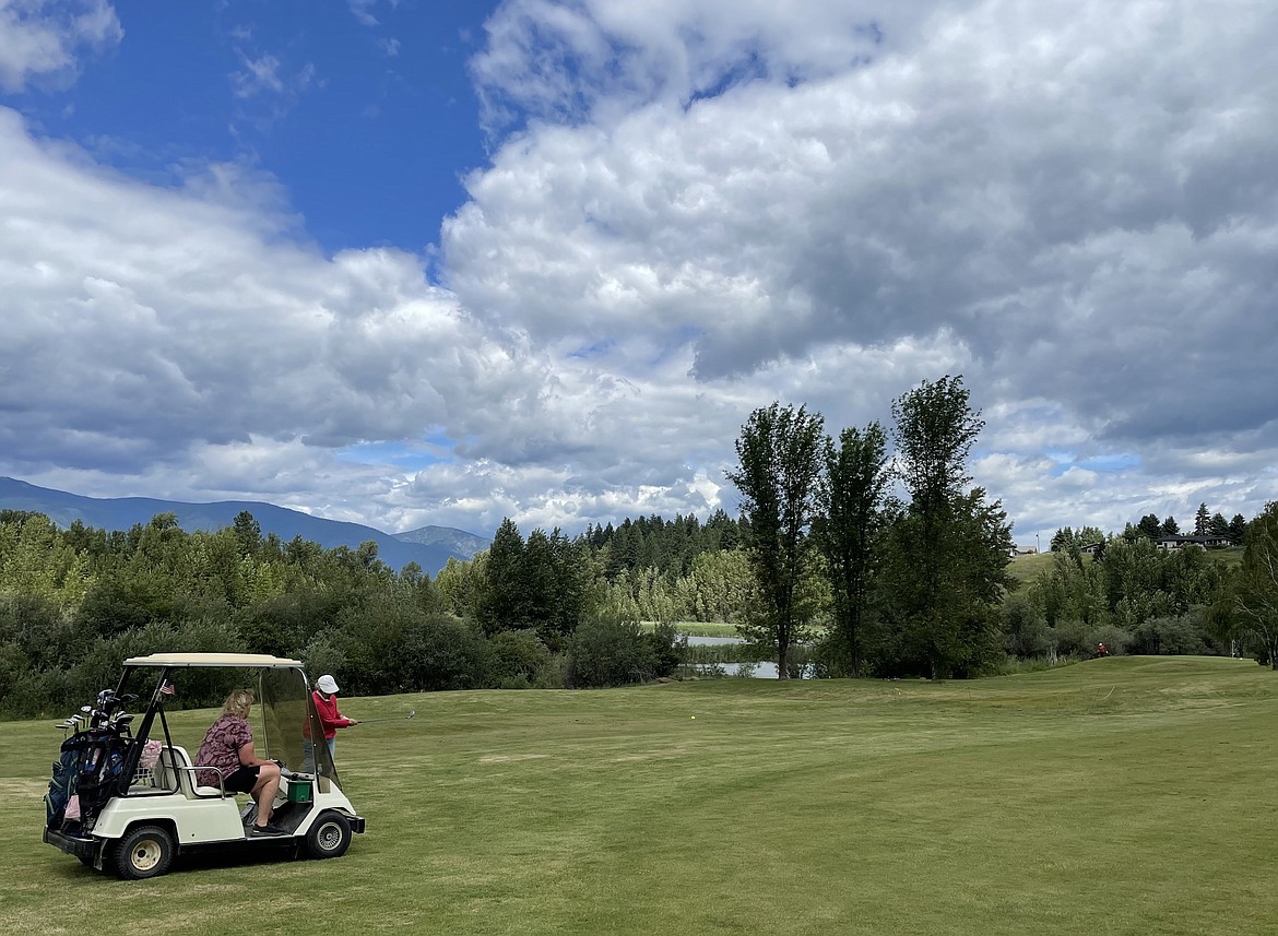 Wendy Hawks watches as Evelyn Rae takes a shot on the fairway on Hole No. 7 during recent play by the Mirror Lake Ladies Golf Club.