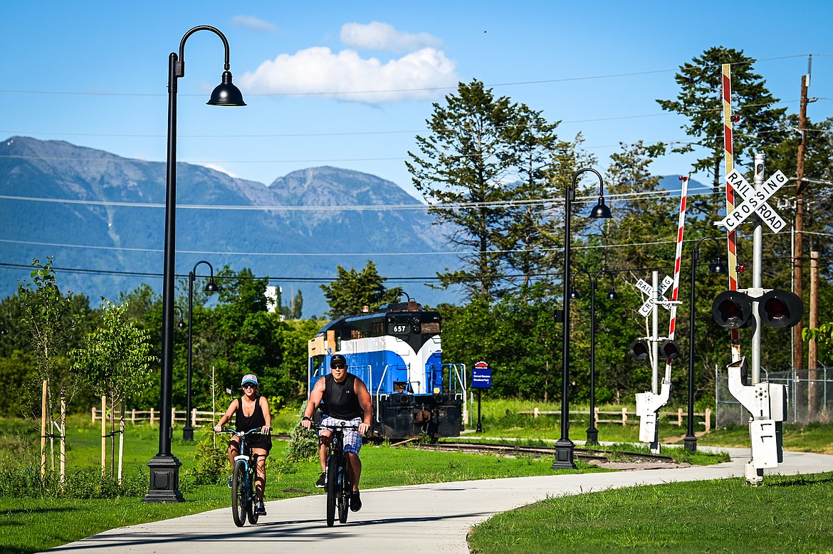 Bella Lauber and Jacob Sherwood ride bikes along the Parkline Trail in Kalispell on Tuesday, July 5. (Casey Kreider/Daily Inter Lake)