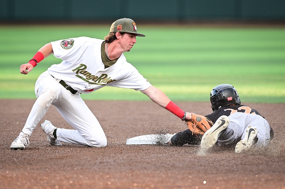Missoula's Cameron Thompson (22) steals second base ahead of the tag by Glacier's Ryan Cash (5) in the fifth inning at Flathead Field on Thursday, July 7. (Casey Kreider/Daily Inter Lake)
