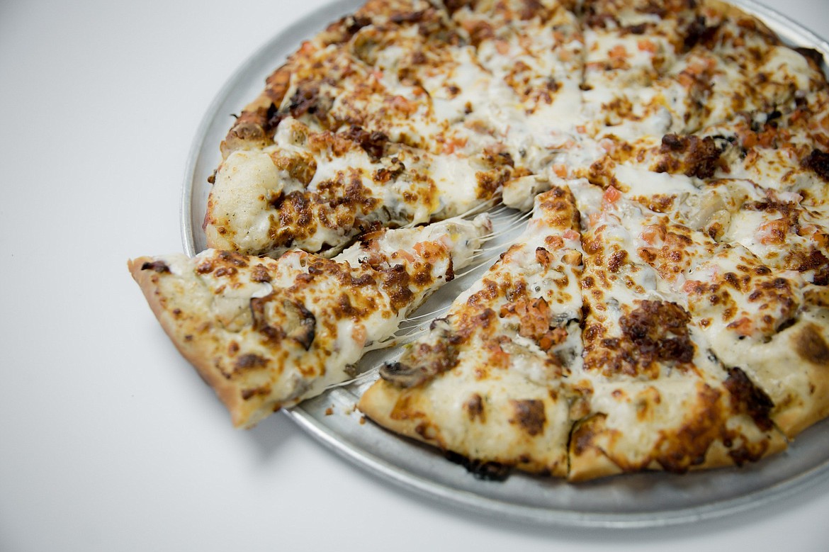 Mushrooms, sausage and white sauce smother a Timeout pizza.