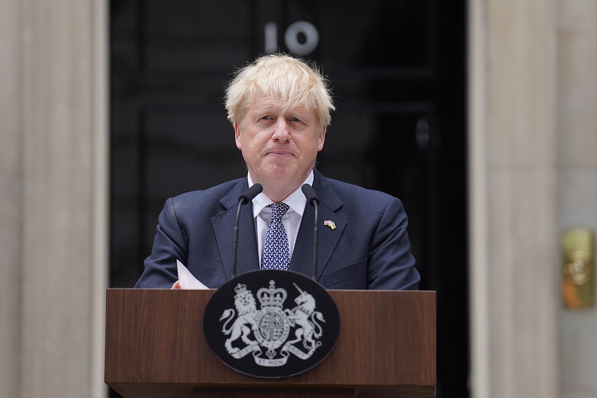 Prime Minister Boris Johnson reads a statement outside 10 Downing Street, London, formally resigning as Conservative Party leader, in London, Thursday, July 7, 2022. Johnson said Thursday he will remain as British prime minister while a leadership contest is held to choose his successor. (Stefan Rousseau/PA via AP)