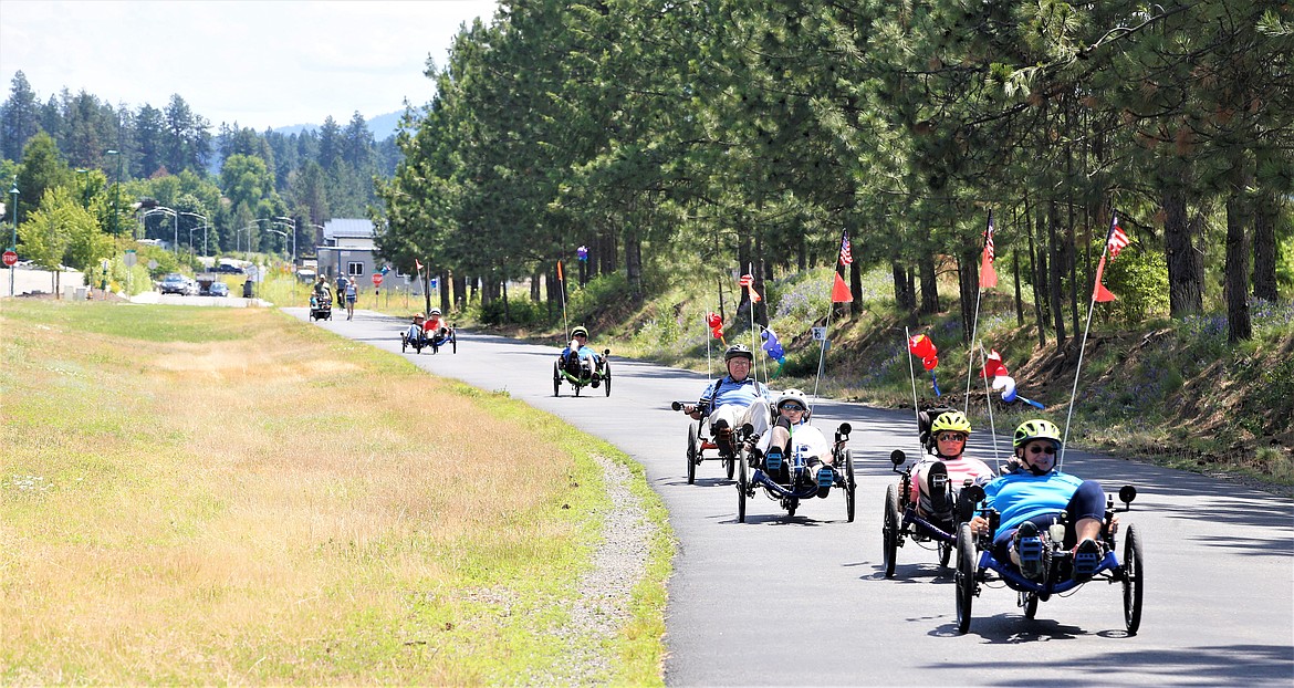 Cyclists ride on a section of the North Idaho Centennial Trail near Riverstone Park, where a greenbelt will be created soon.