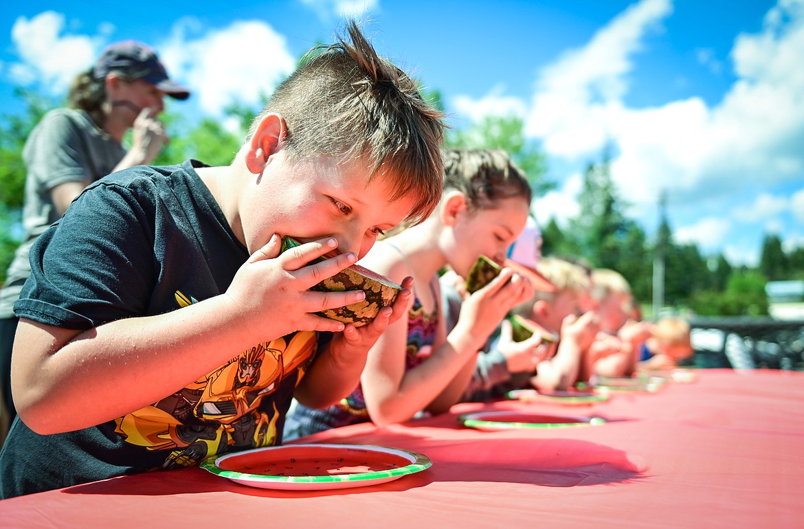 Malcolm Greenfield, from Lakeside, bites into a slice of watermelon during the kids watermelon eating contest at the Lakeside Community Fair on Saturday, July 9. (Casey Kreider/Daily Inter Lake)