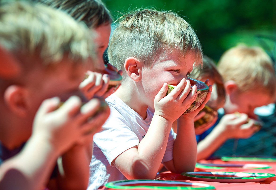 Hudson Russell bites into a slice of watermelon during the kids watermelon eating contest at the Lakeside Community Fair on Saturday, July 9. Russell won first place in his division. (Casey Kreider/Daily Inter Lake)