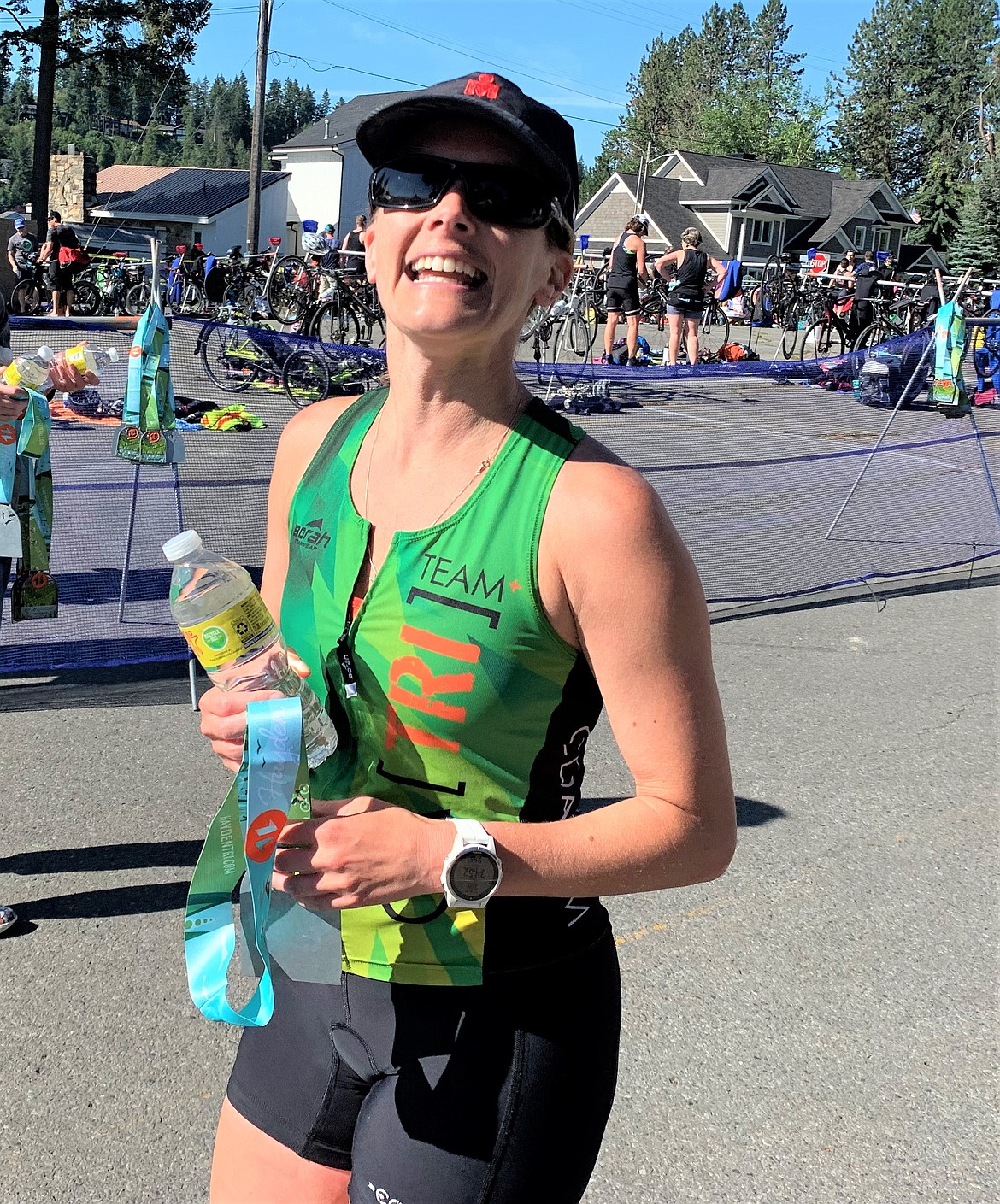 Stephanie Todd of Coeur d'Alene smiles after finishing the Hayden Triathlon and receiving her medal on Saturday.