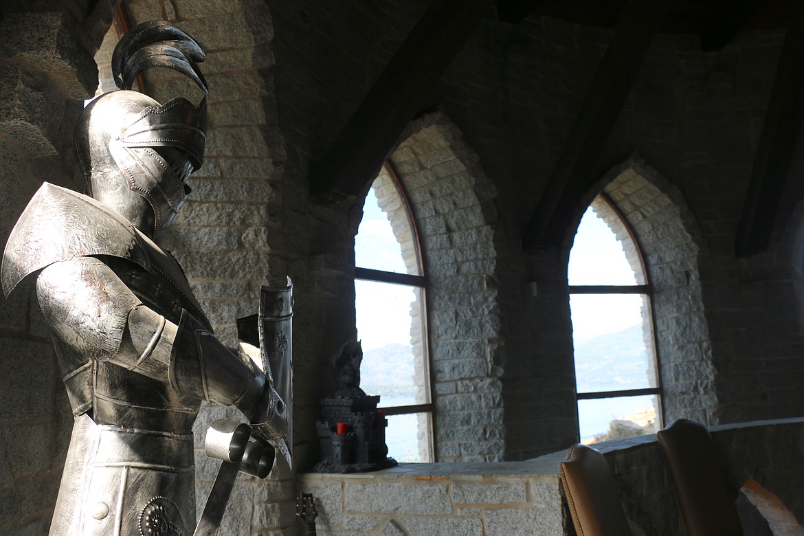 A suit of armor stands guard in the main hallway, a space that would have served as the great hall in a medieval castle.