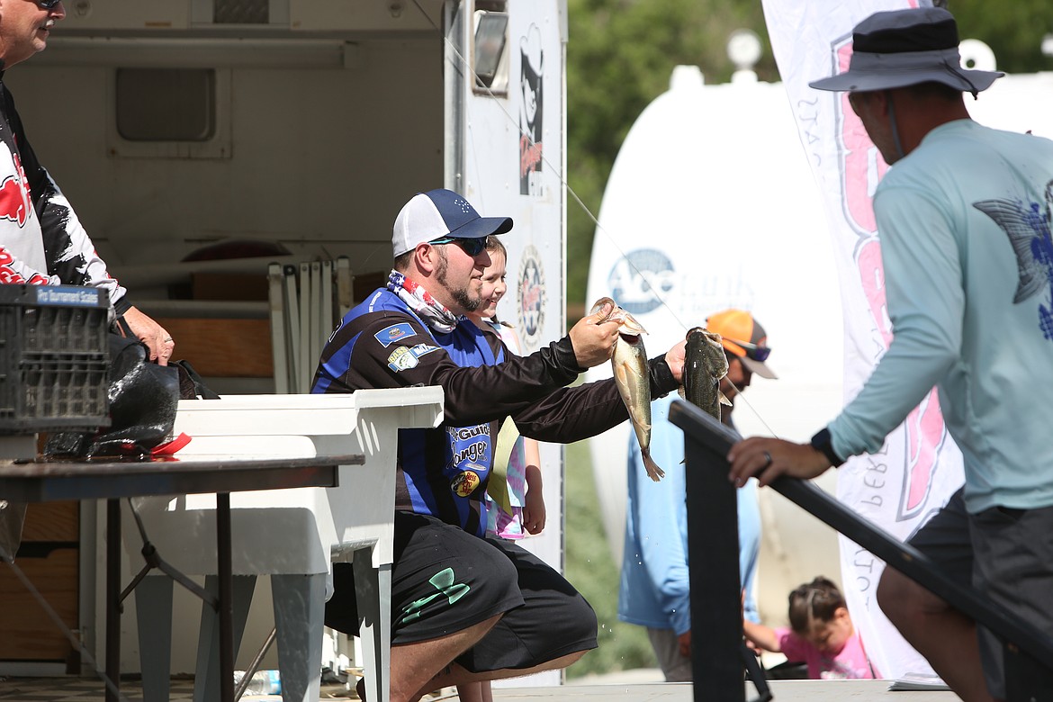 Faces full of smiles, anglers posed with their fish during the weigh-in.