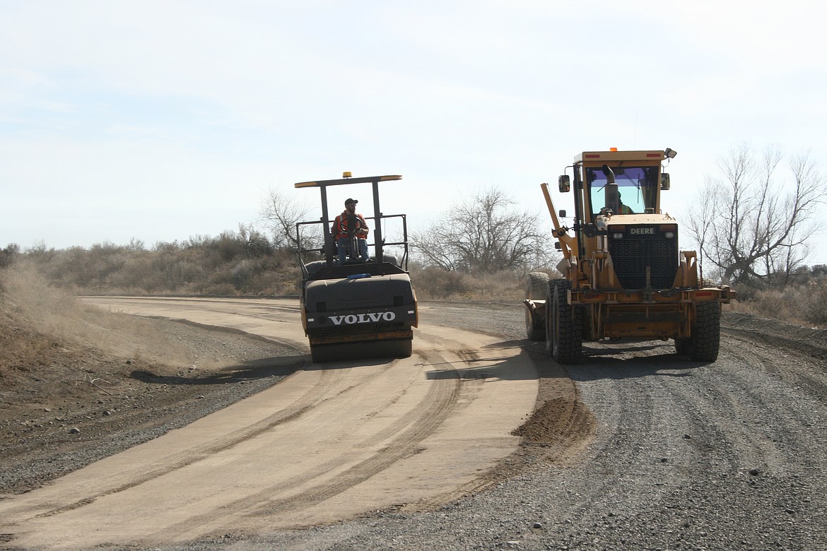 Grant County public works employees work on a road near Moses Lake in 2021. Local government employees experienced the highest increase in wages from 2011 to 2021, according to an economic analysis from the Washington Employment Security Department.