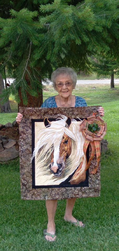 Mary Foley with her quilt last year that won Best in Art Quilts and the Cabin Fever Quilt Exhibition. Foley, 95, is the Featured Quilter this year and her quilt work along with many others will be free to the public to view on August 5 and 6 in the Superior High School Multi-Purpose Room during the Mineral County Fair. (Patty Schiller photo)