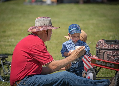 Grandpa Todd Jorgensen and grandson enjoying the festivities. (Tracy Scott/Valley Press)