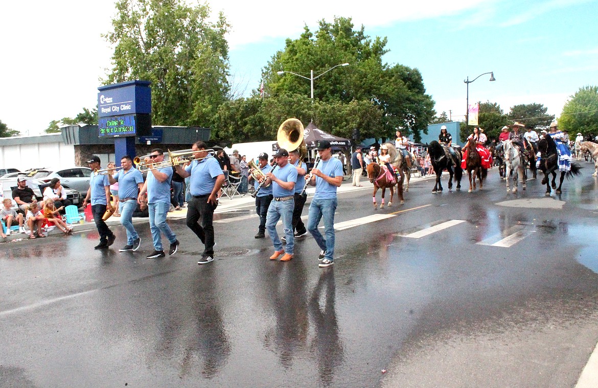 The Royal City Summerfest parade makes its way down Camelia Street Saturday morning.