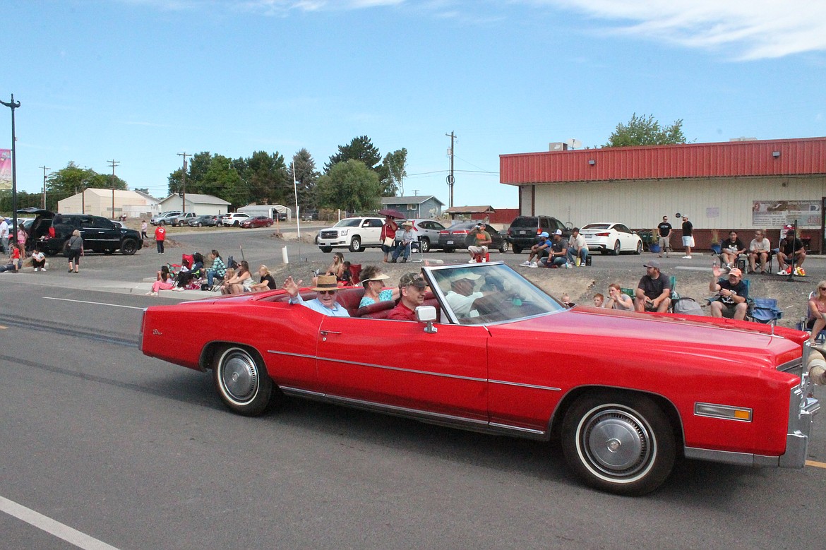 Grand Marshals Bill and Donna Rexius wave to the crowd at the Summerfest parade in Royal City Saturday.