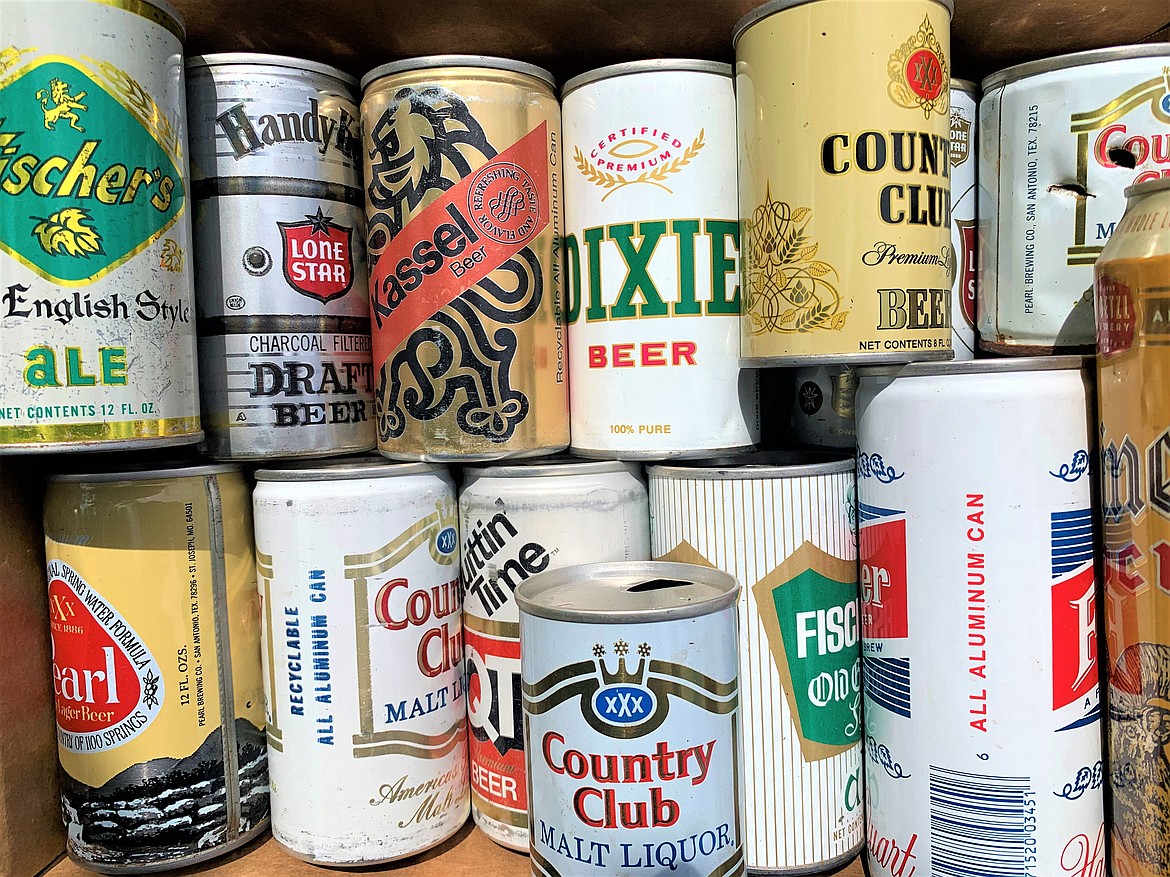 Some of Brock Lambert's beer can collection sits in a box.