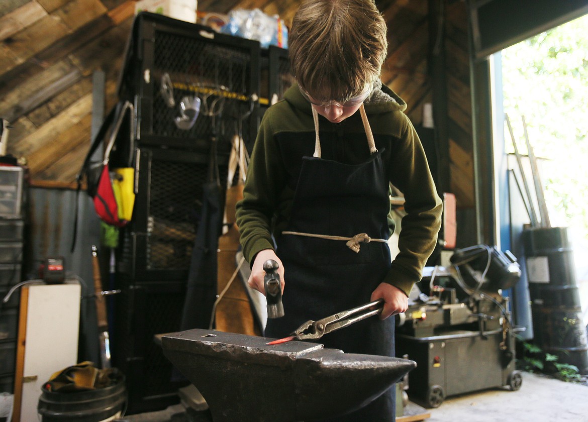 Blacksmith-in-training Leo Adira, 12, works on a project at Fire Iron Forge.