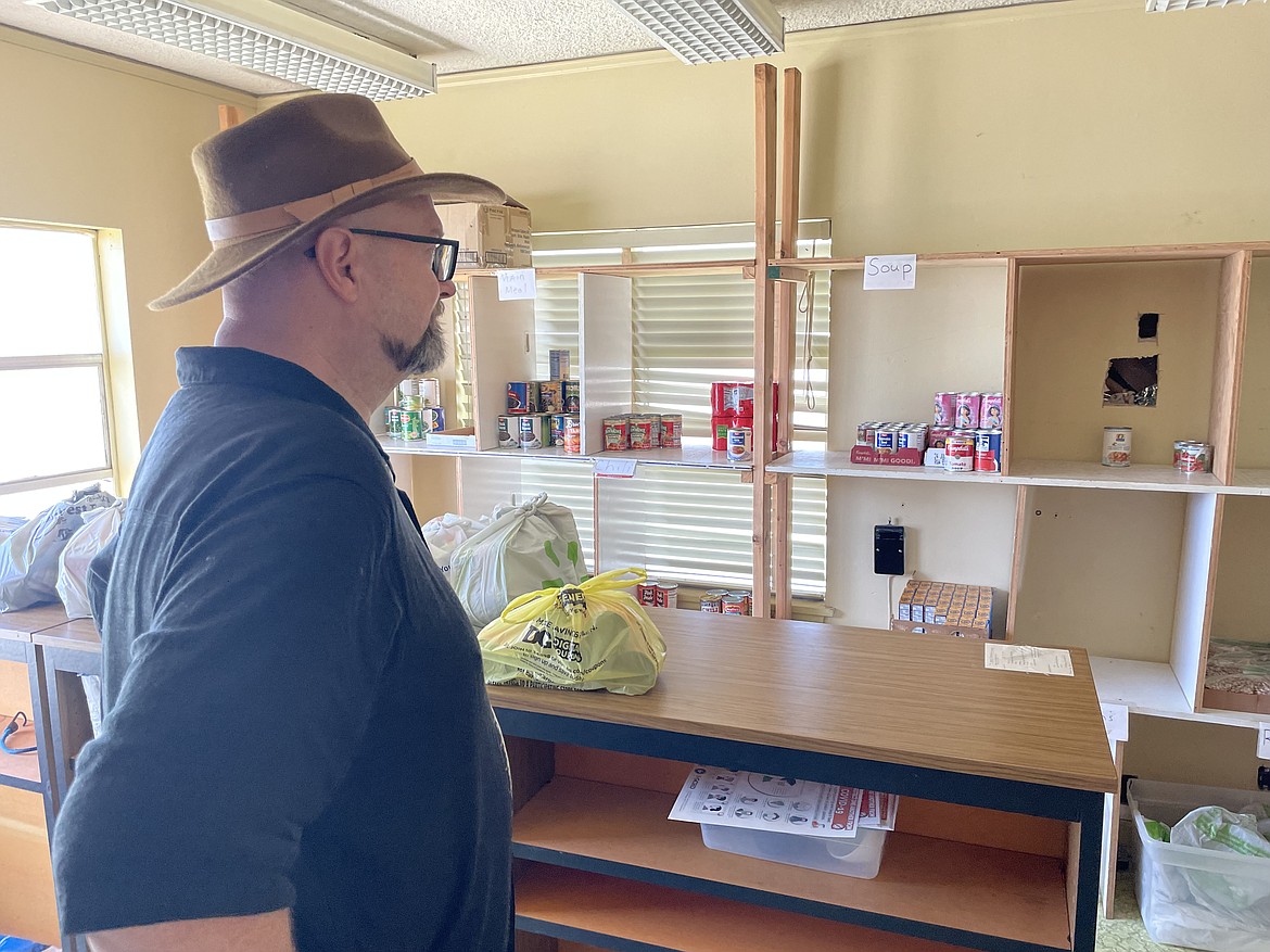 Pastor Ed Backell, coordinator for the Warden Food Pantry, oversees the shelves in the food pantry’s building at the corner of Fifth Street and Maple Drive. Shelves were a little bare last week and the food pantry could use donations from the community or area businesses.