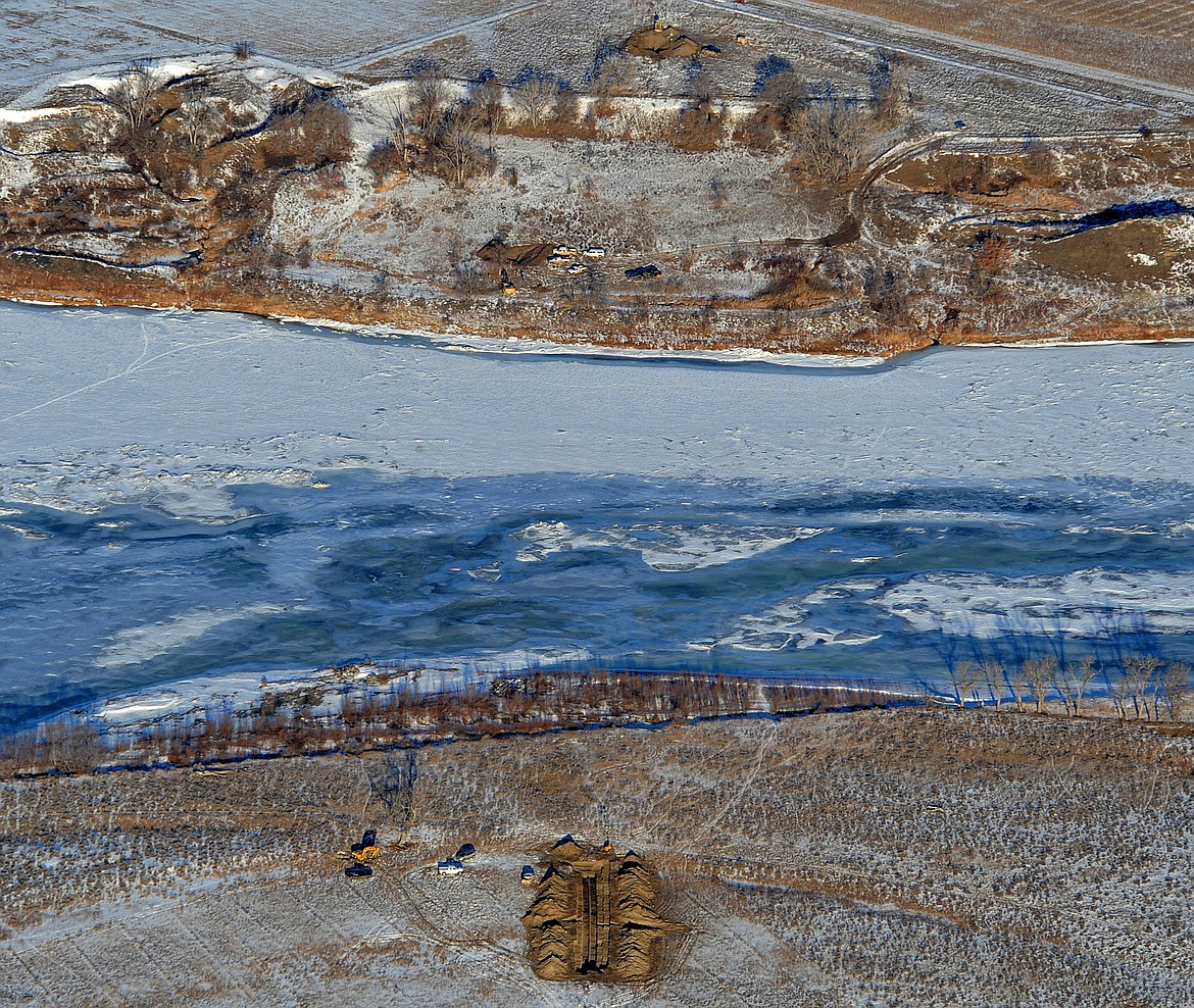 Crews work to contain an oil spill from Bridger Pipeline's broken pipeline near Glendive, Mont., in this aerial view showing both sides of the river. Federal prosecutors are suing the Wyoming-based pipeline company for violations of pollution laws following spills in Montana and North Dakota. (Larry Mayer/The Billings Gazette via AP, File)