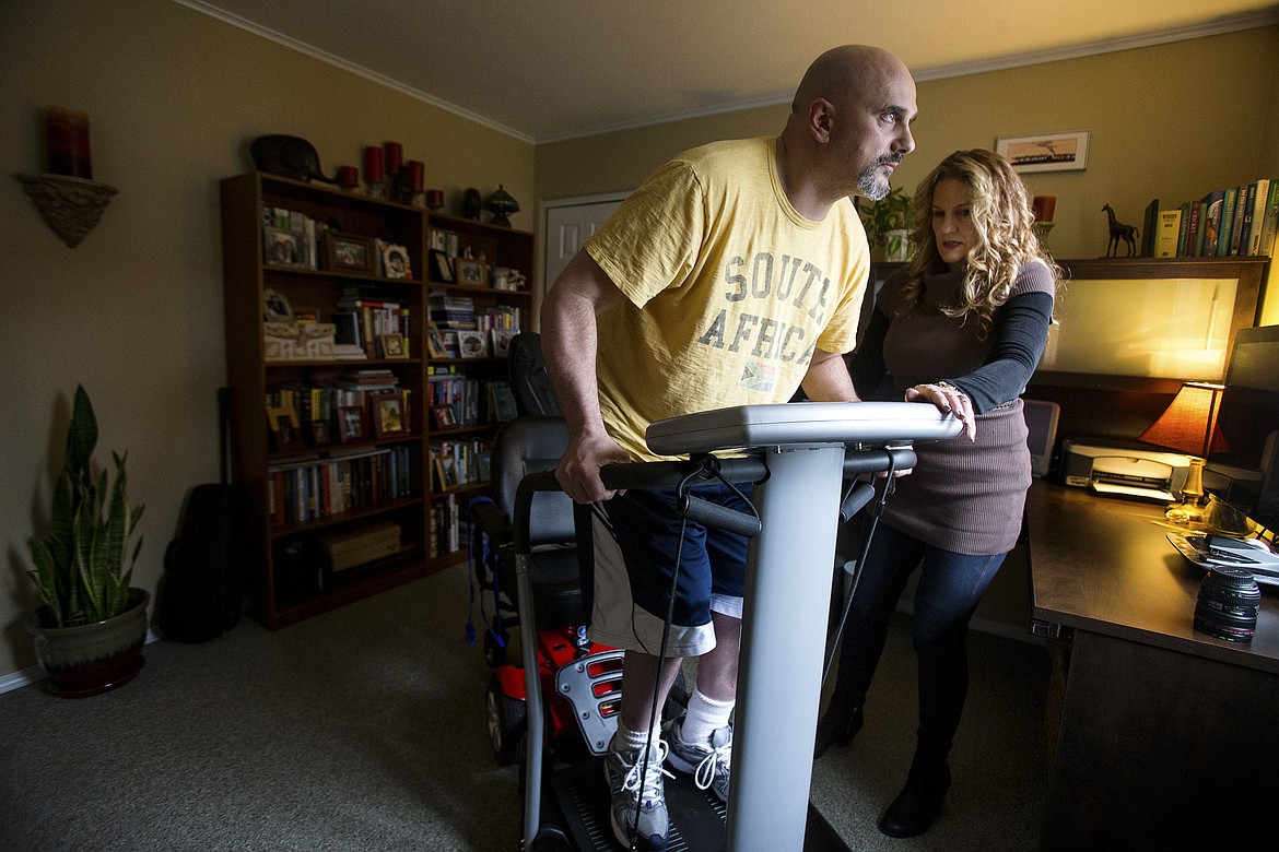 Paula Bates helps her husband Robin Bates onto a whole body vibration machine in their Hayden home in 2014. Robin, who has multiple sclerosis, hopes to have a stem cell transplant to avoid being placed in an assisted living facility. The procedure and associated costs will be at least $50,000.