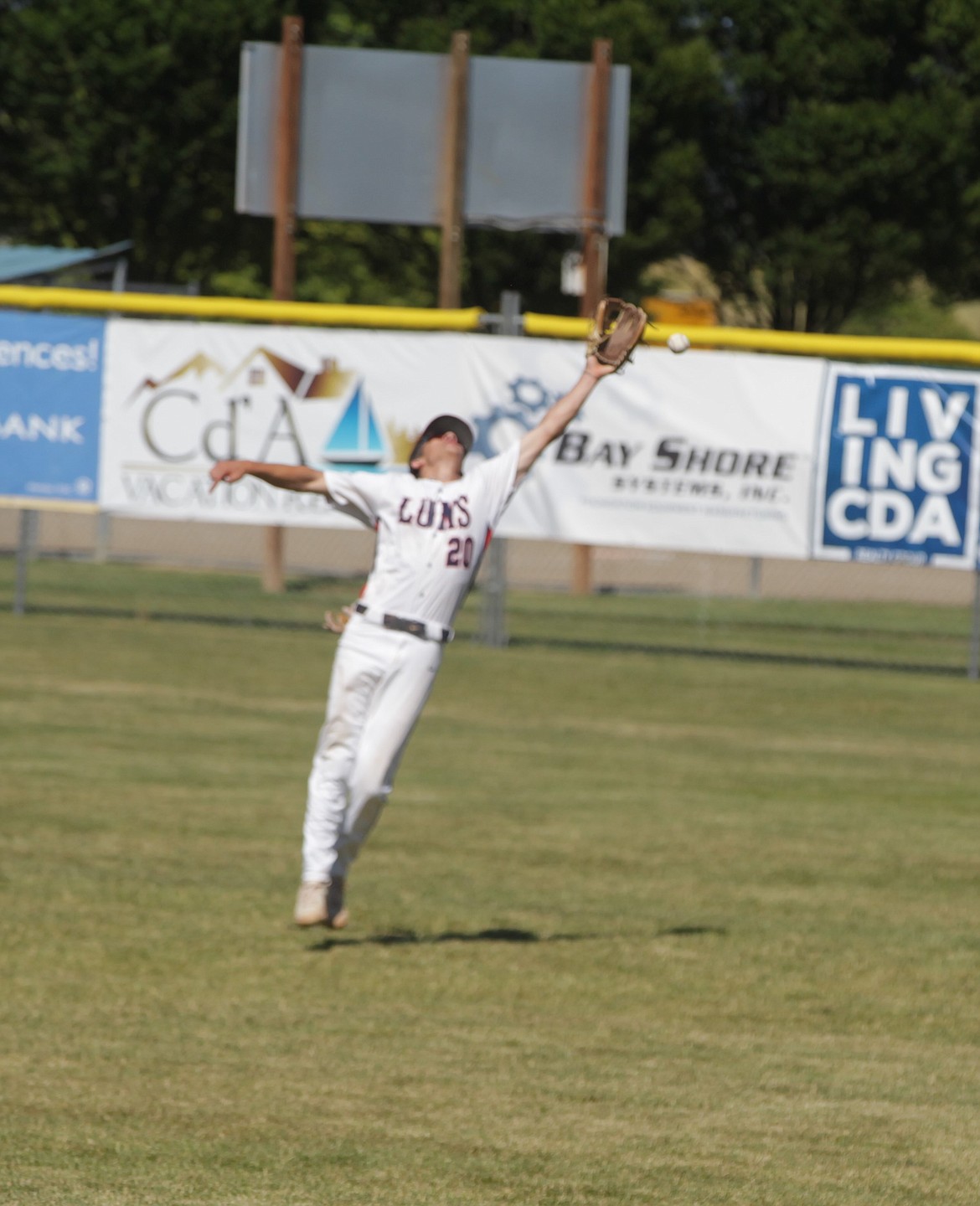 JASON ELLIOTT/Press
Coeur d'Alene Lumbermen right fielder Eric Bumbaugh attempts to catch a fly ball during the third inning of Saturday's opening game in the Class AA Area A best-of-3 series at Thorco Field.