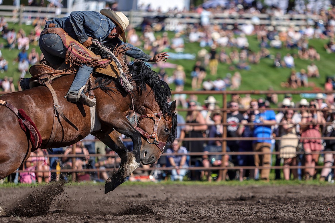 A saddle bronc rider at the rodeo at Under the Big Sky in Whitefish on Friday, July 15, 2022. (JP Edge photo)