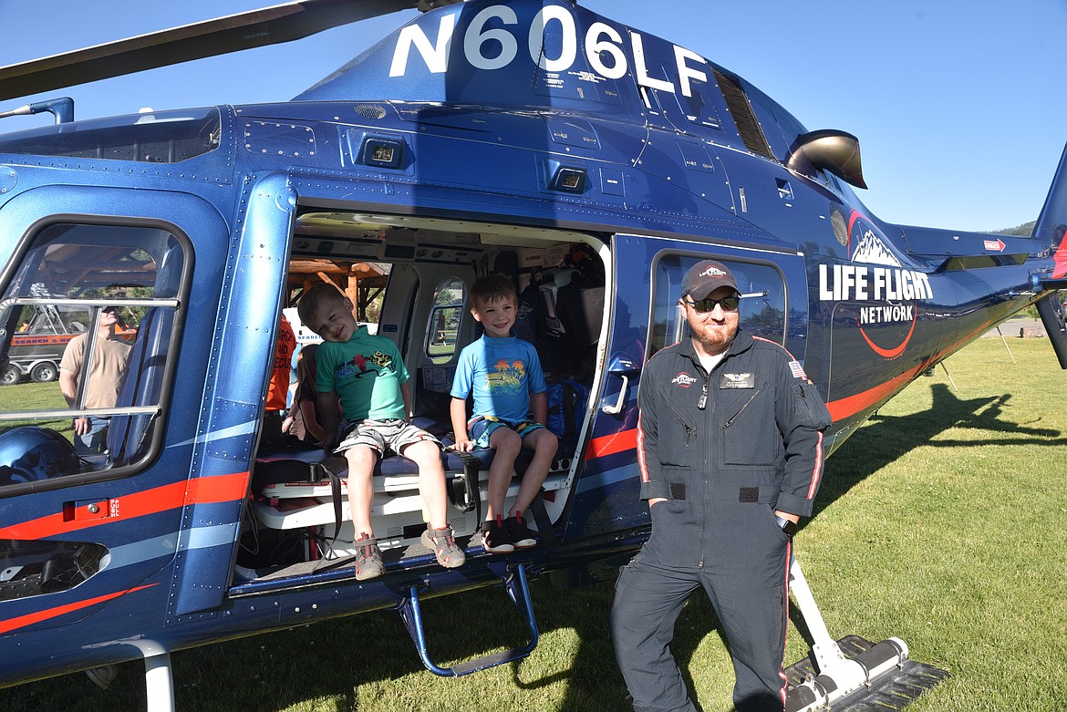 Life Flight paramedic Kelly Hunt stopped for a photo with Libby’s Benson Wicka, left, and Remington Wicka, center, at last Thursday’s water safety presentation at Riverside Park. The air ambulance crew, which includes pilot Olivia Fine, and flight nurse Ben Suttlemyre, is stationed in Sandpoint, Idaho. Its primary coverage includes the counties of Lincoln, Sanders in Montana, and Bonner and Boundary in Idaho. (Scott Shindledecker/The Western News)